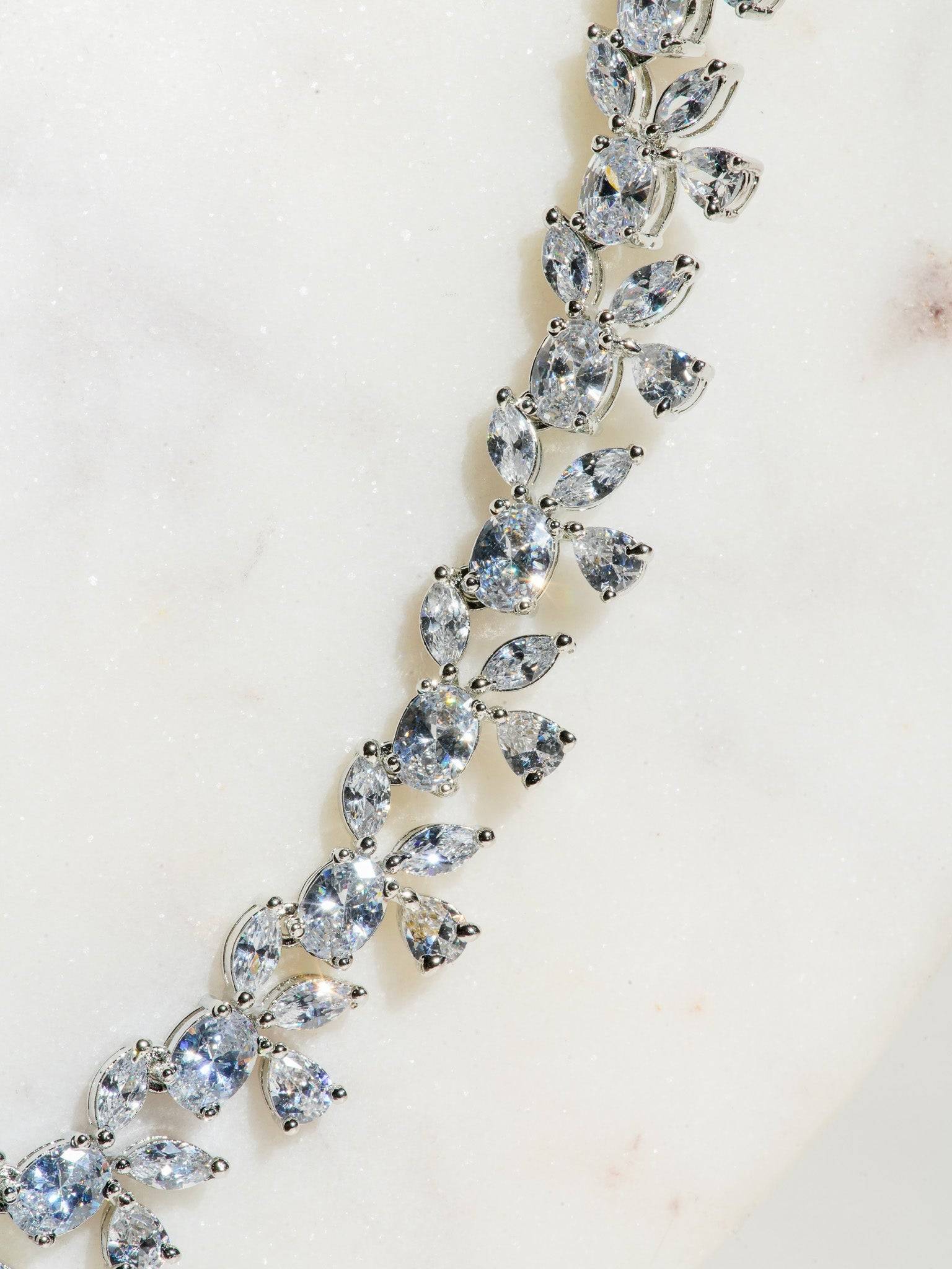 Lama Single Layer Long Diamante Accent AD Necklace Set in rhodium-plated silver or gold finish with intricate floral pattern and matching dangling earrings.