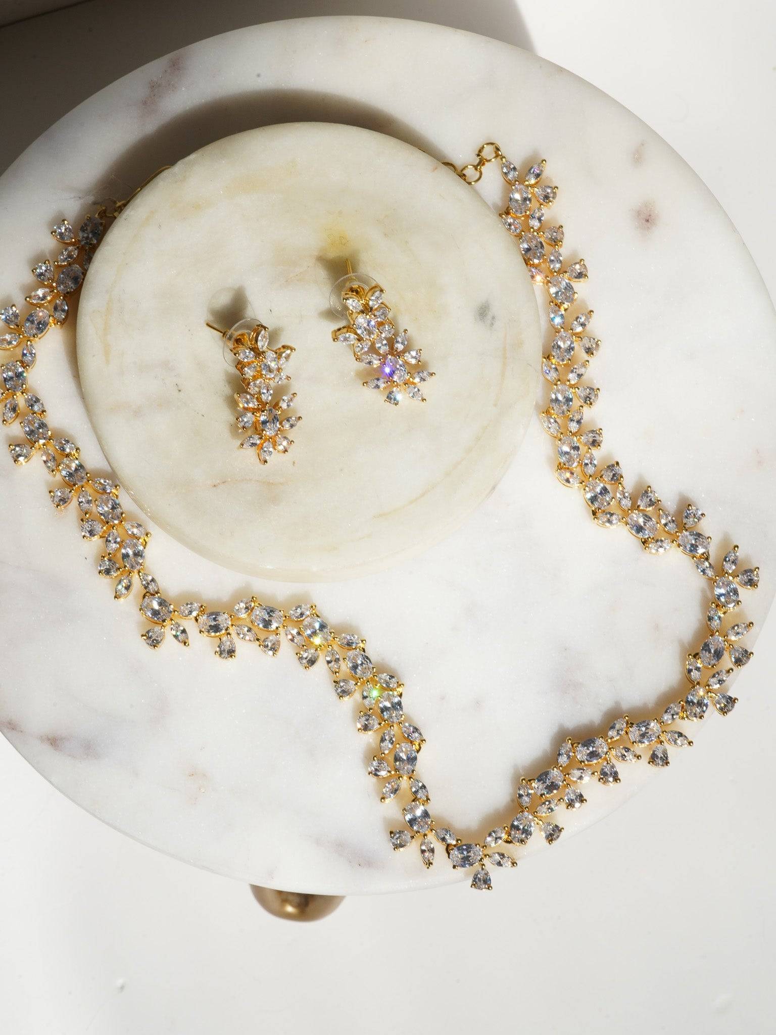 Lama Single Layer Long Diamante Accent AD Necklace Set in rhodium-plated silver or gold finish with intricate floral pattern and matching dangling earrings.