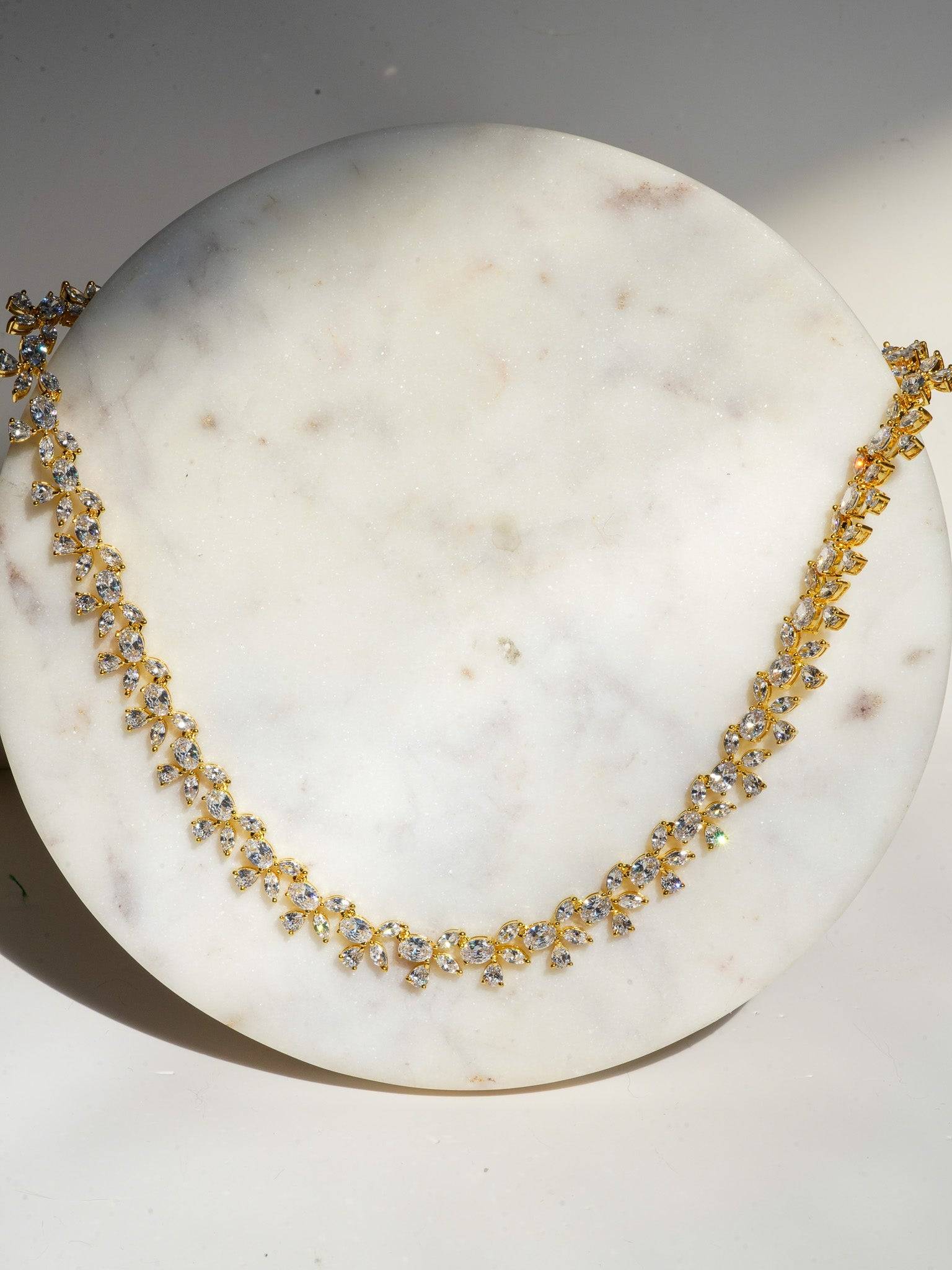 Lama Single Layer Long Diamante Accent AD Necklace Set in rhodium-plated silver or gold finish with intricate floral pattern and matching dangling earrings.