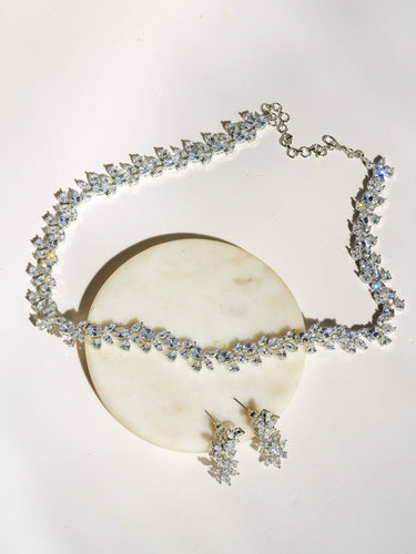 Lama Single Layer Long Diamante Accent AD Necklace Set in rhodium-plated silver or gold finish with intricate floral pattern and matching dangling earrings.