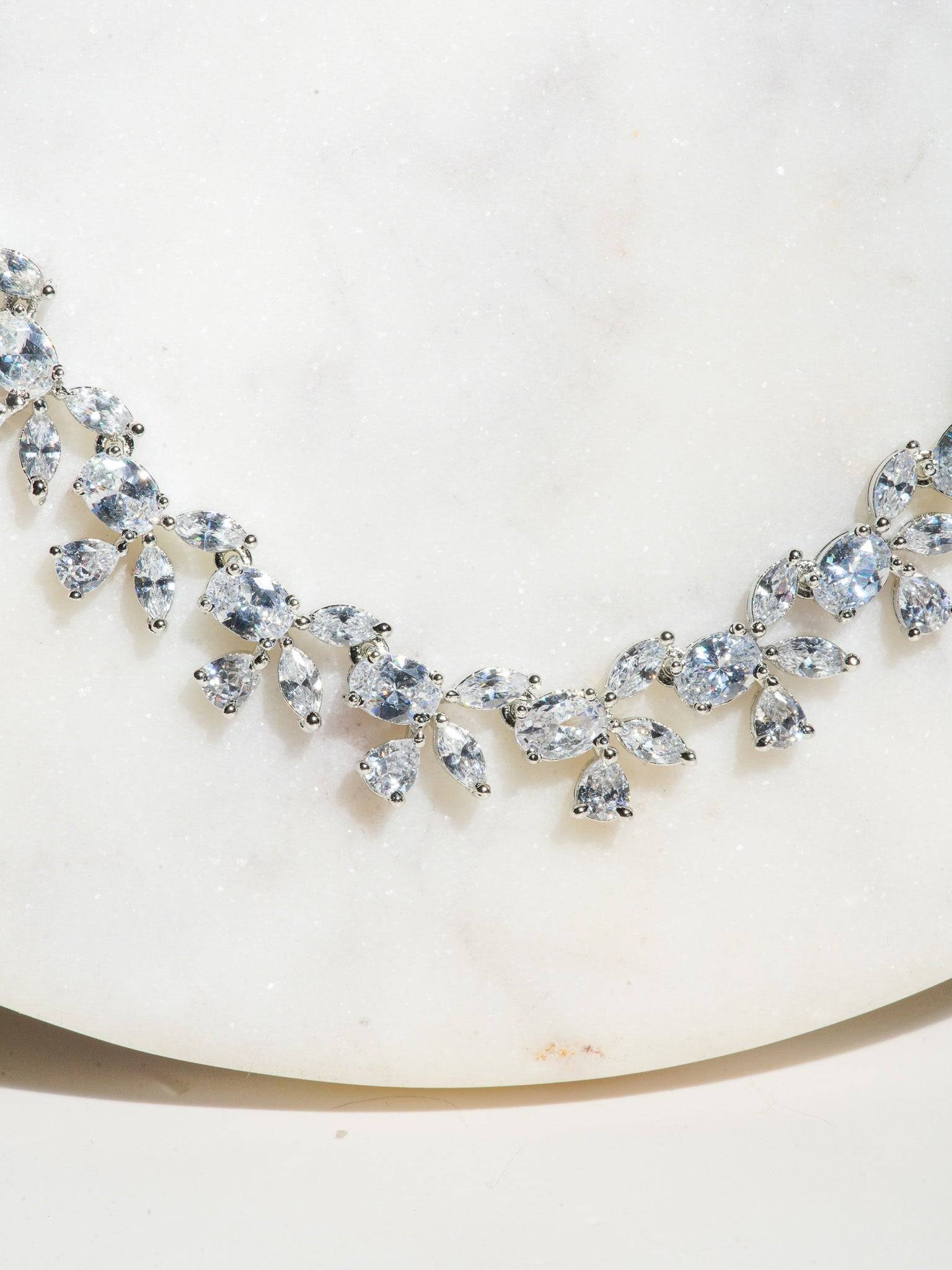 Lama Single Layer Long Diamante Accent AD Necklace Set in rhodium-plated silver or gold finish with intricate floral pattern and matching dangling earrings.