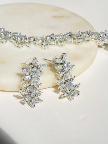 Lama Single Layer Long Diamante Accent AD Necklace Set in rhodium-plated silver or gold finish with intricate floral pattern and matching dangling earrings.
