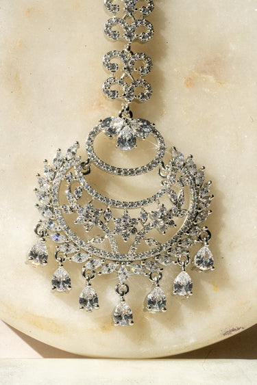 Close-up of Liza Rhodium-Plated AD Maang Tikka in white, highlighting dazzling CZ stones and intricate filigree work.