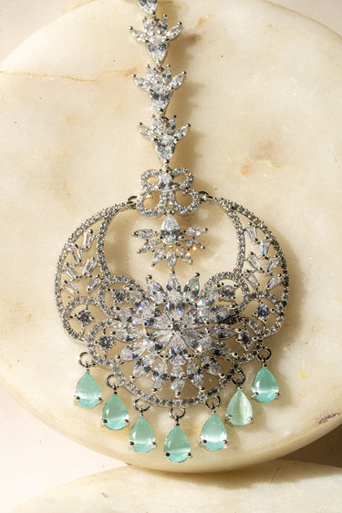 Rhodium-plated maang tikka with American Diamonds and mint green teardrop accents from Inaury