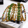 Meera 7-piece gold-plated bangle set with ruby and emerald accents from Inaury, floral design with diamante stones