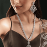 Silver-toned long statement pendant necklace and earring set with green accent stones - South Asian jewelry - Inaury