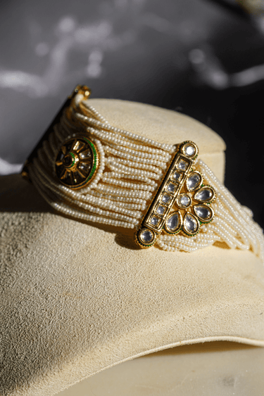 Mona Pearl Moissanite Polki Choker Set – Indian Jewelry featuring layered pearl strands, central floral moissanite polki motif, and gold accents.