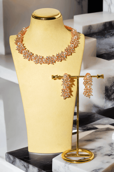 Mukta Diamante Accent AD Necklace Set - Rhodium or rose gold-plated finish, adorned with AD stones and faux pearls, featuring intricate floral patterns and matching minimal earrings.