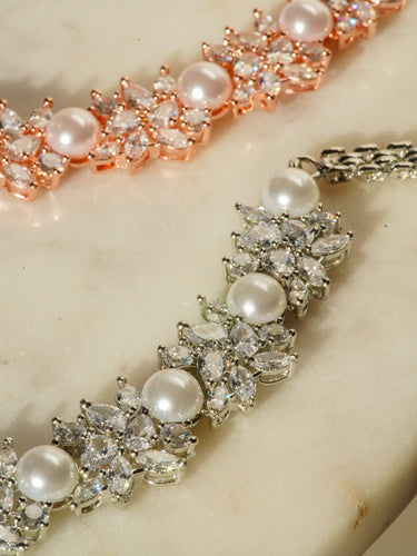 Mukta Diamante Accent AD Necklace Set - Rhodium or rose gold-plated finish, adorned with AD stones and faux pearls, featuring intricate floral patterns and matching minimal earrings.