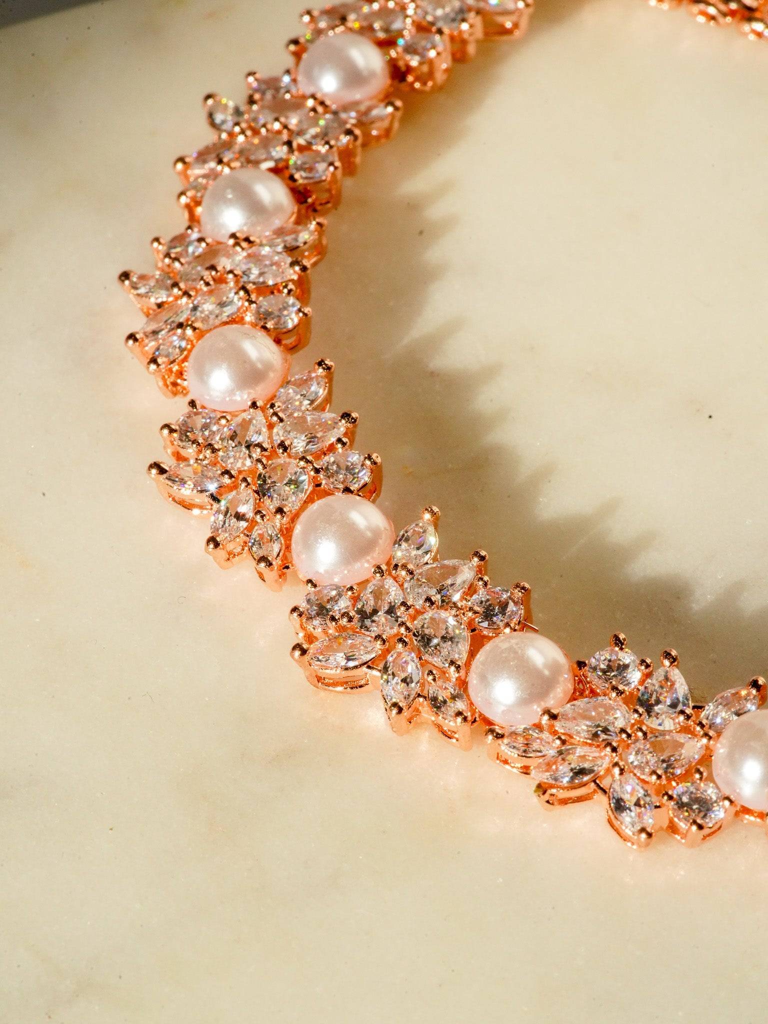 Mukta Diamante Accent AD Necklace Set - Rhodium or rose gold-plated finish, adorned with AD stones and faux pearls, featuring intricate floral patterns and matching minimal earrings.