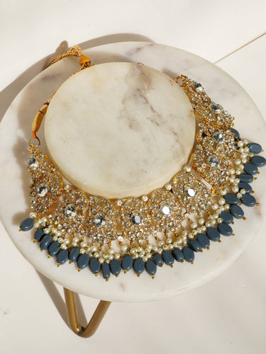 Nazanin Gold Plated Teal Bridal Set - 6-piece collection with gold plating, white zircon stones, teal blue beads, including jhumka earrings, choker, classic necklace, long necklace, jhoomer, and maang tikka.