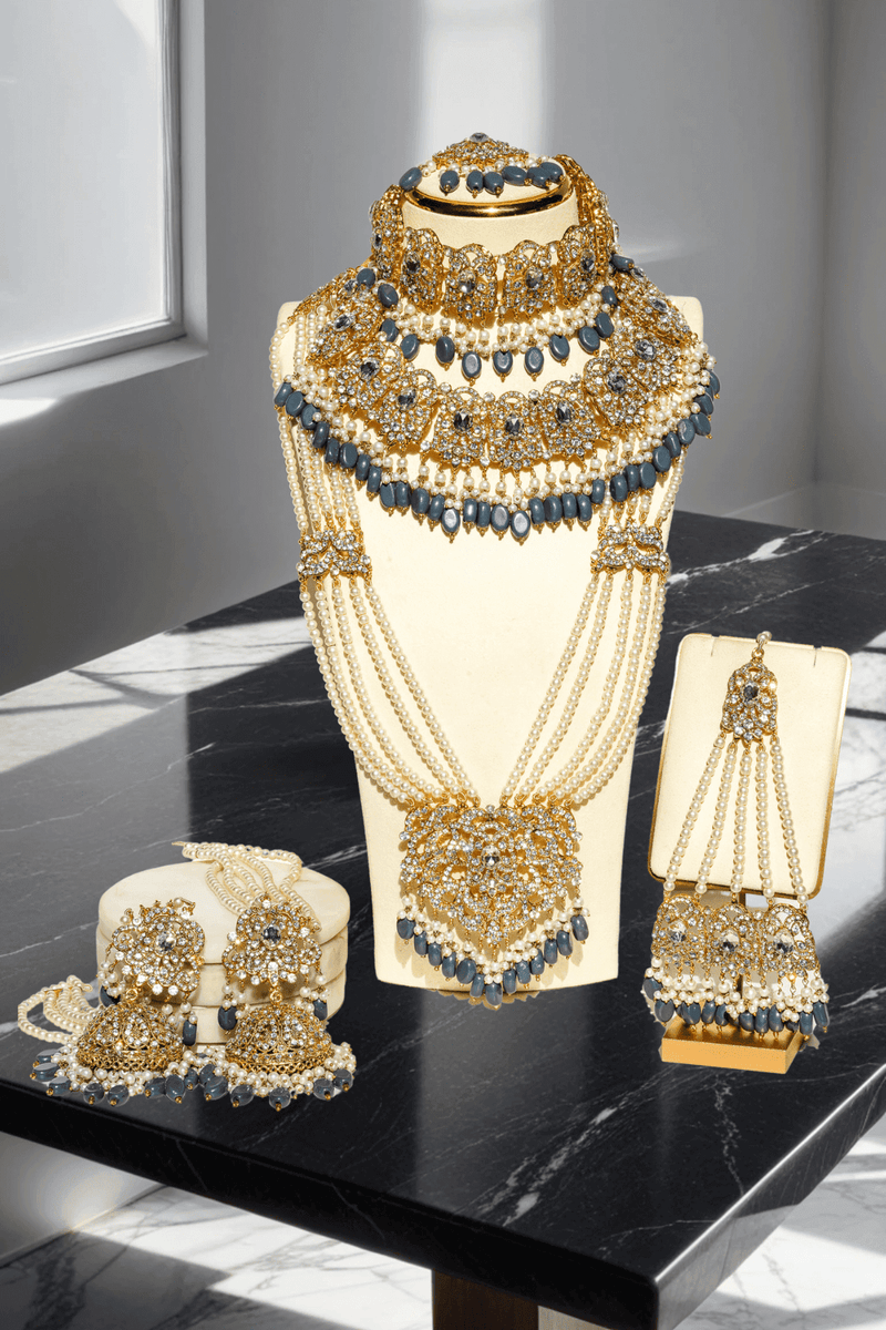 Nazanin Gold Plated Teal Bridal Set - 6-piece collection with gold plating, white zircon stones, teal blue beads, including jhumka earrings, choker, classic necklace, long necklace, jhoomer, and maang tikka.