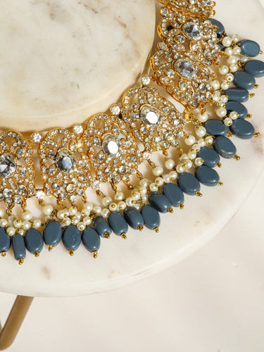 Nazanin Gold Plated Teal Bridal Set - 6-piece collection with gold plating, white zircon stones, teal blue beads, including jhumka earrings, choker, classic necklace, long necklace, jhoomer, and maang tikka.