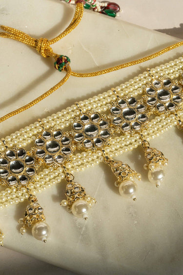 Neeshy champagne gold plated choker necklace set with resin bead detailing , paired with jhumka earrings and maang tikka from Inaury