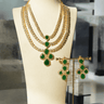 Niara Triple Layer Diamante Accent AD Necklace Set in gold or rhodium-plated silver finish with color options of silver & sapphire blue, silver & green, gold & green, and silver & ruby, featuring triple-layered chain links and matching statement earrings.
