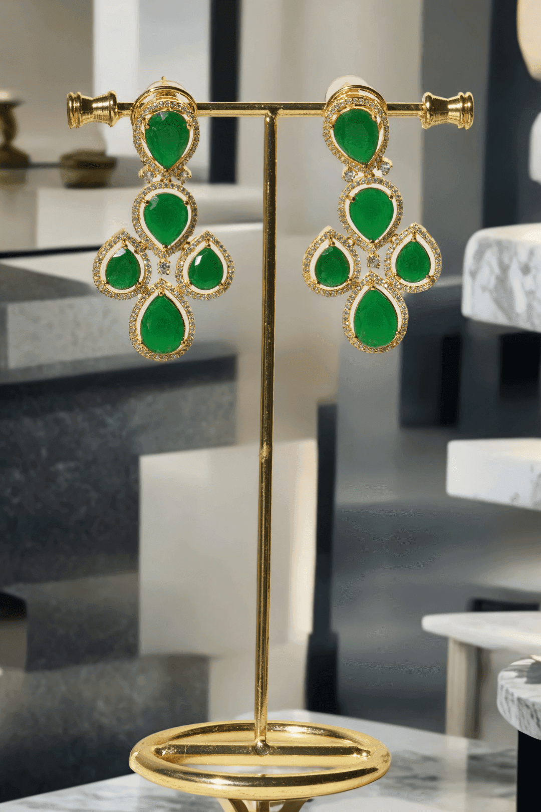 Niara Triple Layer Diamante Accent AD Necklace Set in gold or rhodium-plated silver finish with color options of silver & sapphire blue, silver & green, gold & green, and silver & ruby, featuring triple-layered chain links and matching statement earrings.