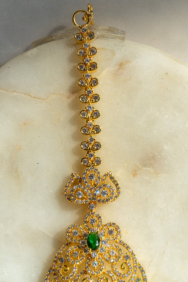 Gold and green maang tikka with American Diamond accents and teardrop dangles from Inaury.com