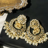 Nura Kundan Chandbali earrings displayed on black surface