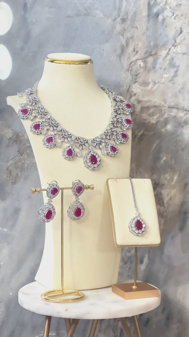 Pink Purvi Diamante Necklace Set - Bridal Indian Jewelry on display stand with matching earrings and maang tikka, perfect for bridal styling.