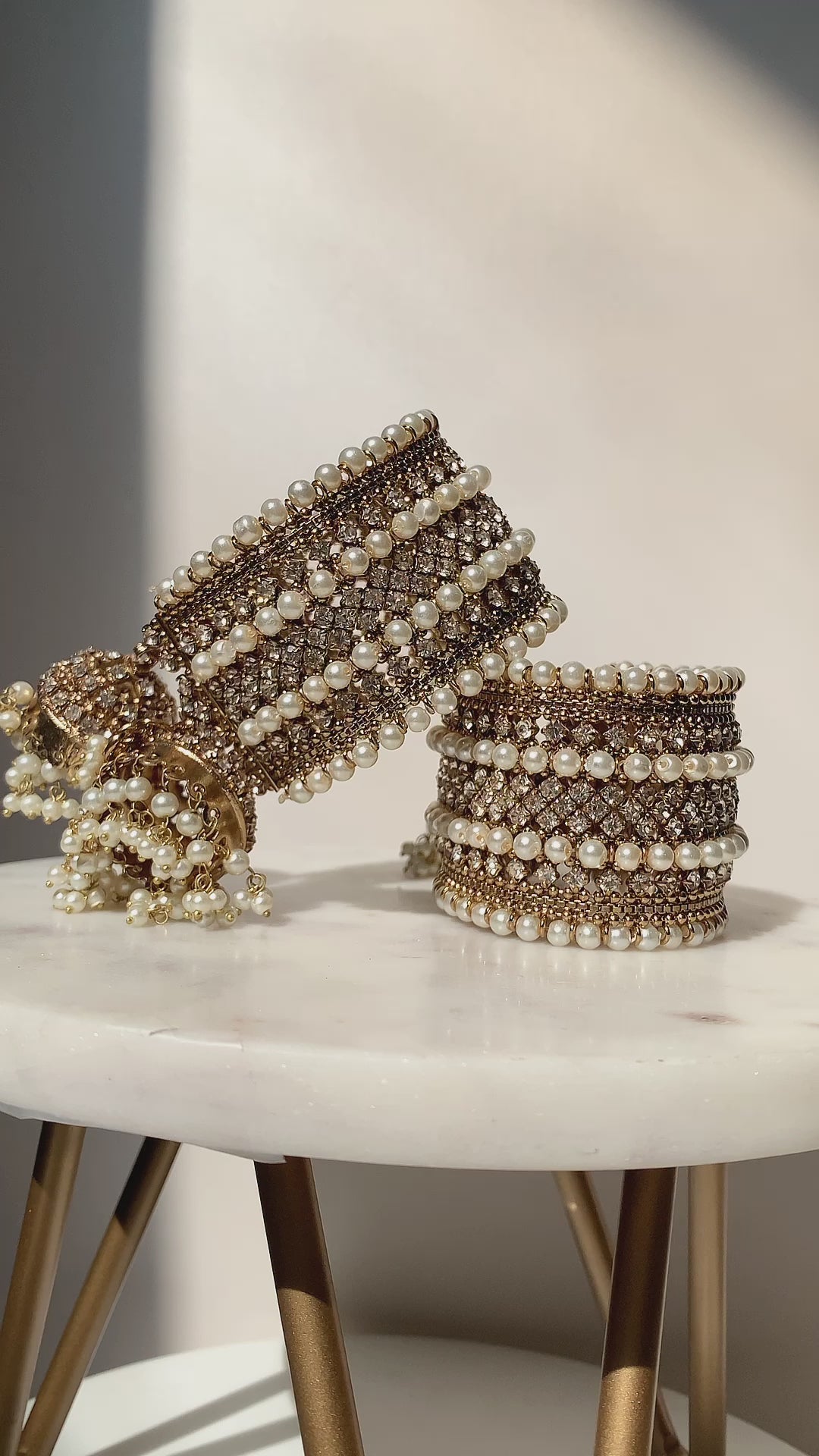 Set of 2 Samia Bangles with gold, pearl, and CZ stones, displayed upright to showcase intricate jhumka accents and traditional craftsmanship.
