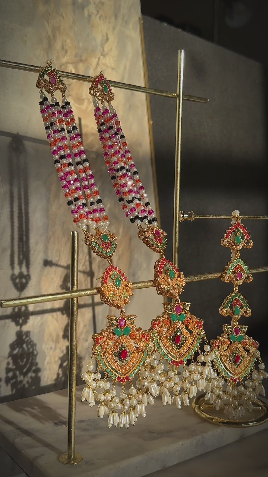 Traditional Sanjana Earrings & Tikka Set featuring vibrant Navratan stones and pearl tassels, ideal for festive and bridal wear.