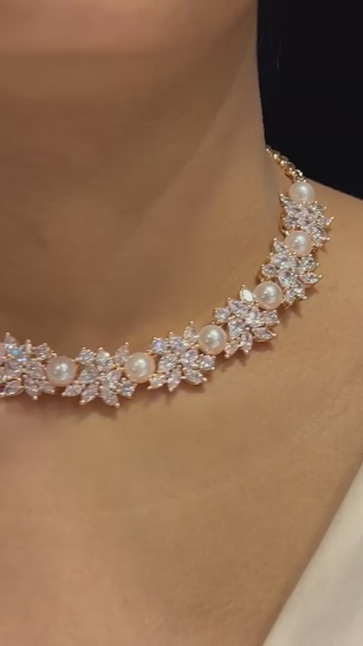 Mukta Diamante Accent AD Necklace Set - Rhodium or rose gold-plated finish, adorned with AD stones and faux pearls, featuring intricate floral patterns and matching minimal earrings.