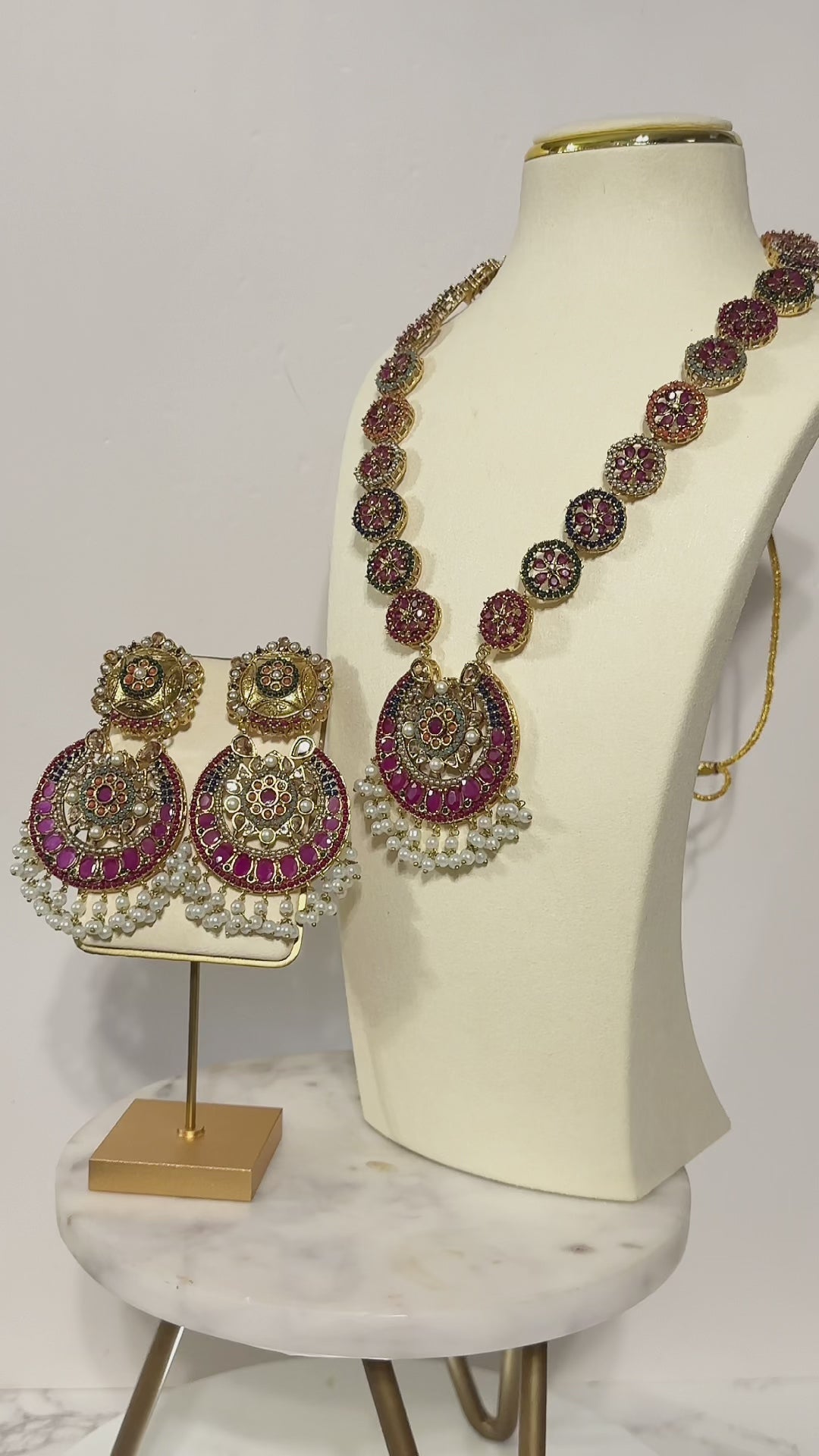 Adiva Necklace Set - Gold Mala featuring intricate stonework and pearls, showcased on a mannequin with coordinating earrings.