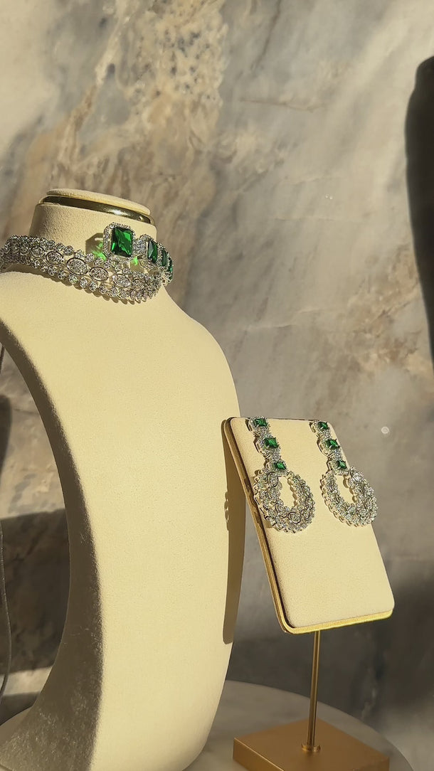 Mahi Asymmetrical Choker Necklace Set - Rhodium-plated with AD stones, available in silver & green, silver & ruby, and silver & sapphire blue, perfect for contemporary elegance.