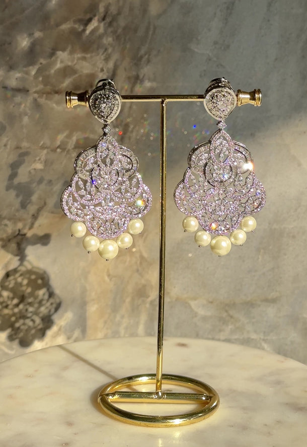 Irene Radiant Pearl Drop Earrings, rhodium-plated with intricate filigree design, pavé white stones, and pearl drops, 3.4 inches long - Indian jewelry for festive and wedding occasions.