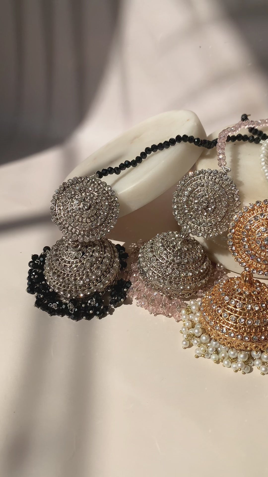Assorted Tabiha Jhumka Earrings in silver and gold with black, pink, and pearl accents, showcasing multiple color options.