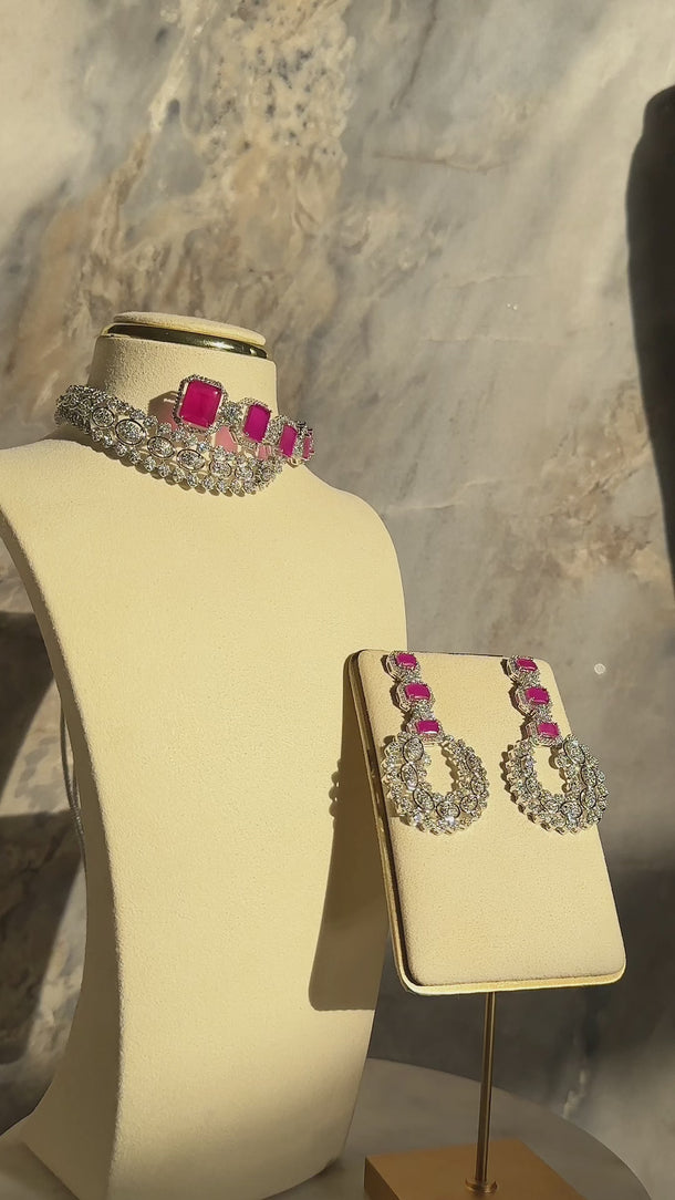 Mahi Asymmetrical Choker Necklace Set - Rhodium-plated with AD stones, available in silver & green, silver & ruby, and silver & sapphire blue, perfect for contemporary elegance.