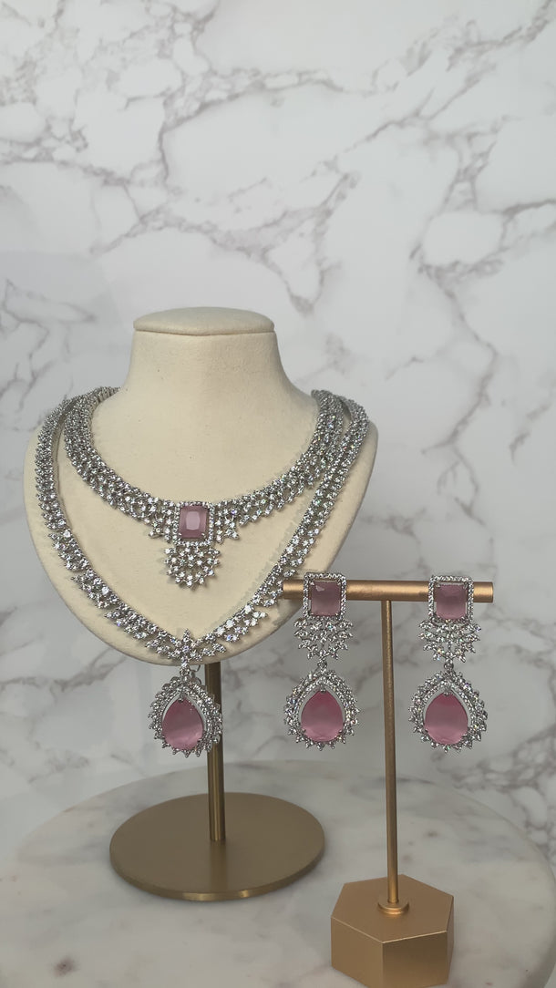 Amore Double Layer AD Necklace Set - Rhodium-plated with sparkling AD stones, available in sapphire blue or pink, featuring matching earrings and a double-layered design.