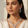 Model wearing Inaury's Brishti rhodium-plated necklace set with white teardrop diamante stones and Bvlgari-inspired openwork detail