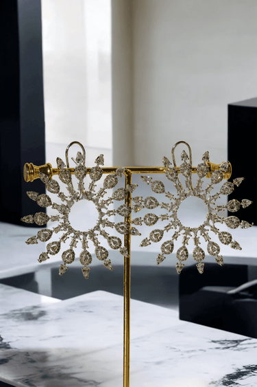 Starburst Statement Earrings with rhodium plating and pavé stones on a gold stand; 2.3-inch oversized studs with secure hook backs for elegance.