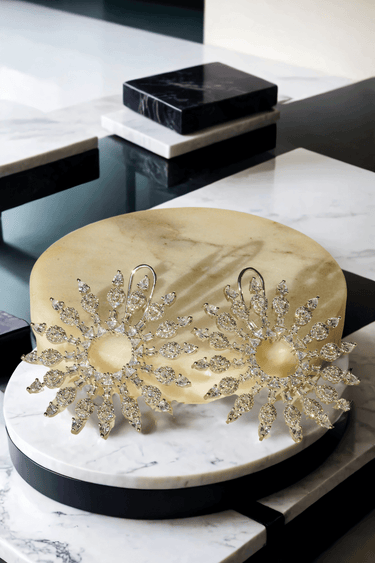 Starburst Statement Earrings with rhodium plating and pavé stones on a gold stand; 2.3-inch oversized studs with secure hook backs for elegance.