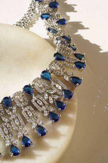 Macro shot of Aagya AD Necklace Set – Rhodium Plated in blue, emphasizing the sparkle of CZ and teardrop stones.