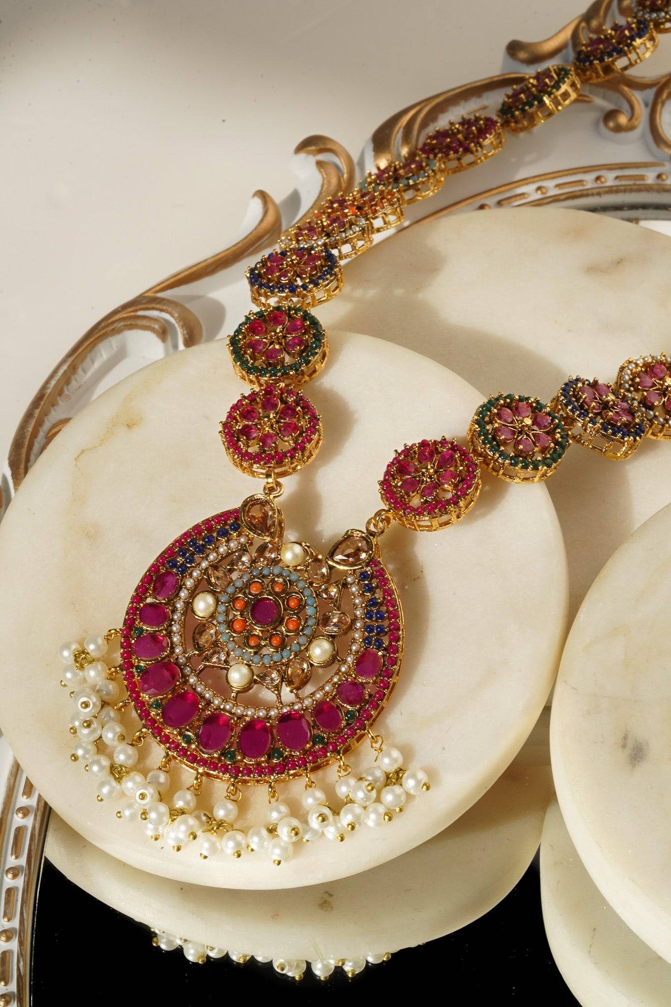 Gold plated Adiva Necklace with colorful stones and pearl drops, displayed in a close-up to show pendant details.