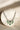 Aneesha Diamante Accent AD Necklace Set - Rhodium-finished with emerald green, maroon, or dusty pink accents, featuring a statement necklace and matching earrings.