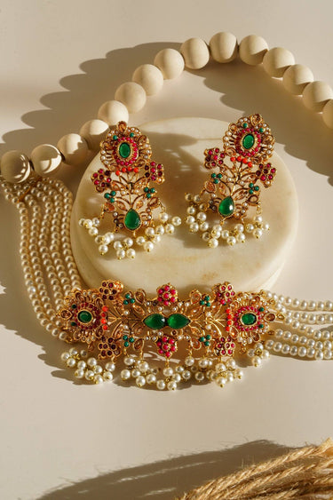 Arushi Pearl Choker Set with Navratan stones and pearl strands, featuring gold-plated floral design and matching earrings.