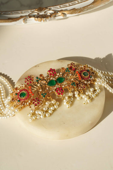 Detailed view of Arushi Pearl Choker Set highlighting gold-plated craftsmanship and vibrant Navratan stones.