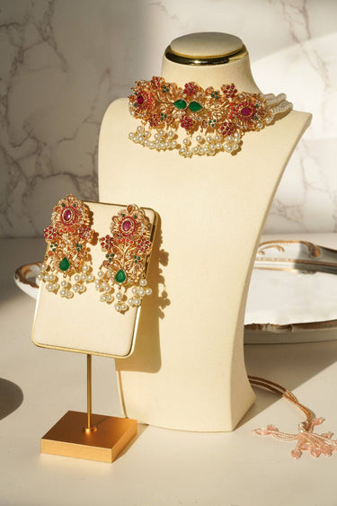 Elegant Arushi Pearl Choker Set on display stand, showcasing detailed Navratan work and pearl embellishments.
