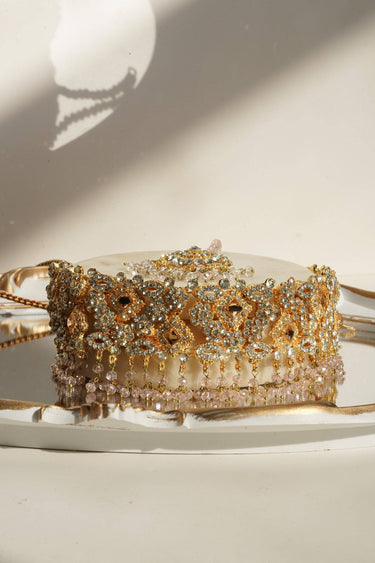 Ayesha Choker Necklace with pink beads and gold floral pattern, styled on a marble tray for elegant presentation.