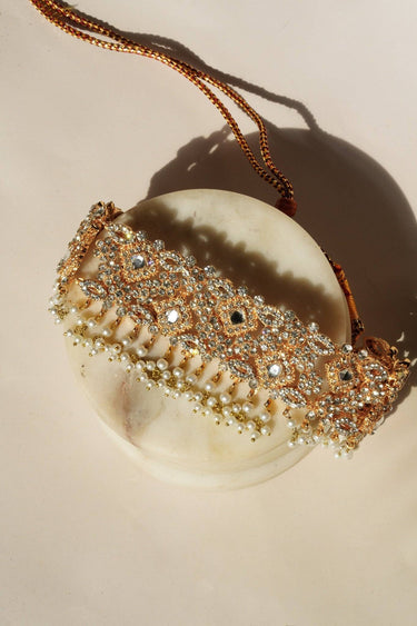 Full Ayesha Choker Necklace Set with white pearls, earrings, and Maang Tikka, styled on marble slabs for luxury appeal.