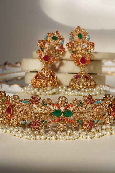 Detailed view of Chaya Navratan choker necklace and earrings set with green, red, and pearl embellishments, ideal for bridal jewelry.