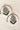 Esmeray Silver Earrings with black bead strands and ornate design, styled on marble for traditional jewelry display.
