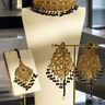 Customizable Esmeray Gold Choker Set with black bead accents, matching earrings, and tikka, perfect for traditional celebrations.
