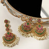 Inaya Earring & Maang Tikka Set - Statement | Chandbali featuring pink and green Navratna stones with pearls, styled beside a mirror.