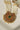 Inza Mala Necklace pendant with green gemstone centerpiece and vibrant multicolor stones, emphasizing traditional craftsmanship.