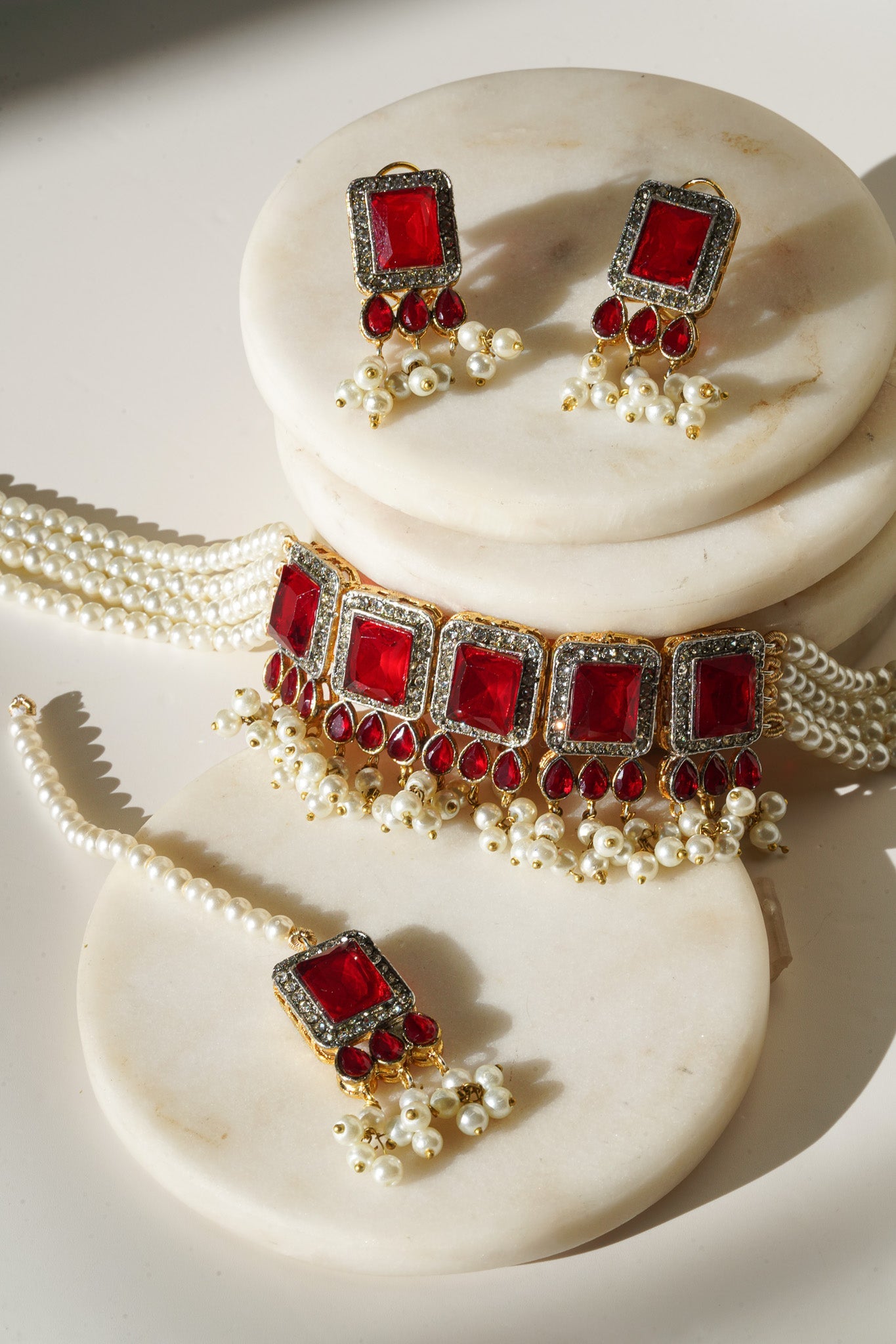 Jahanara Gold Plated Choker Necklace Set - Artisan crafted with cushion cut center stones, zircon rims, teardrop accents, 1.5" earrings, and a charming maang tikka.