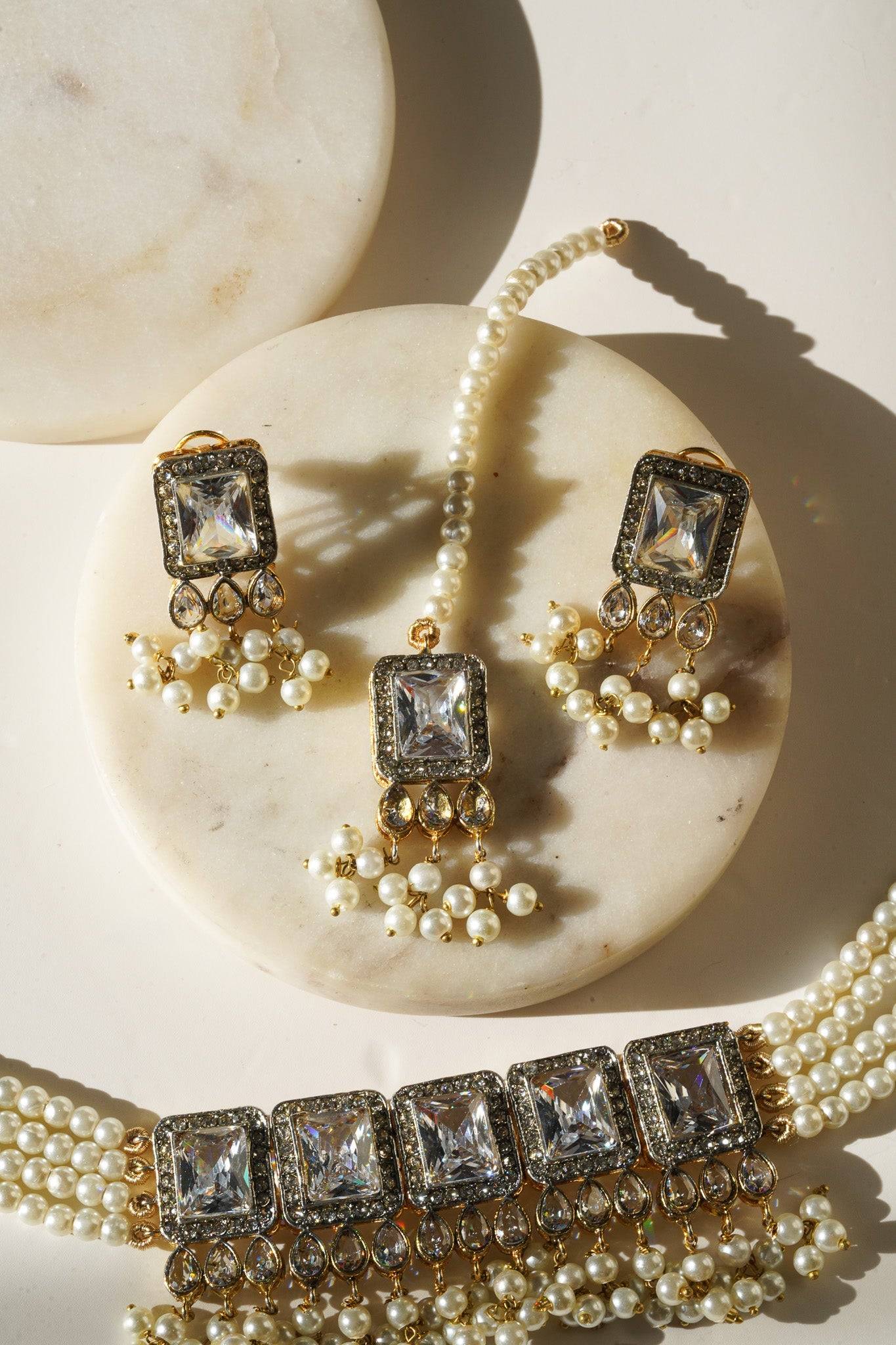 Jahanara Gold Plated Choker Necklace Set - Artisan crafted with cushion cut center stones, zircon rims, teardrop accents, 1.5" earrings, and a charming maang tikka.